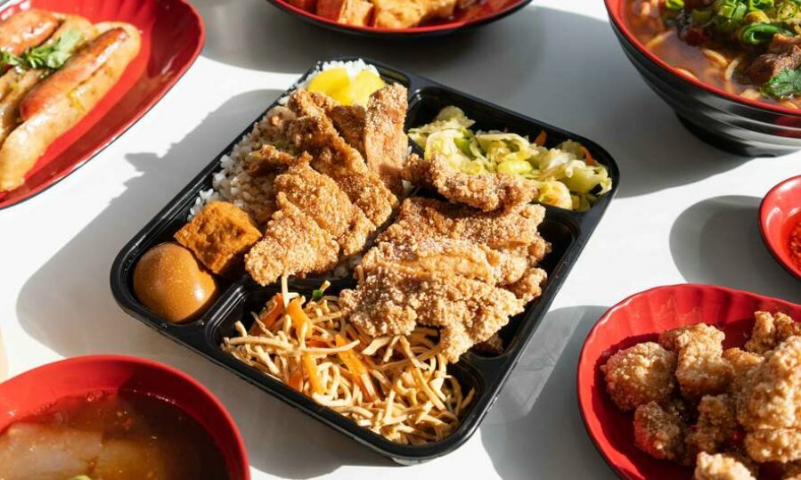 A large piece of fried chicken in a plastic tray