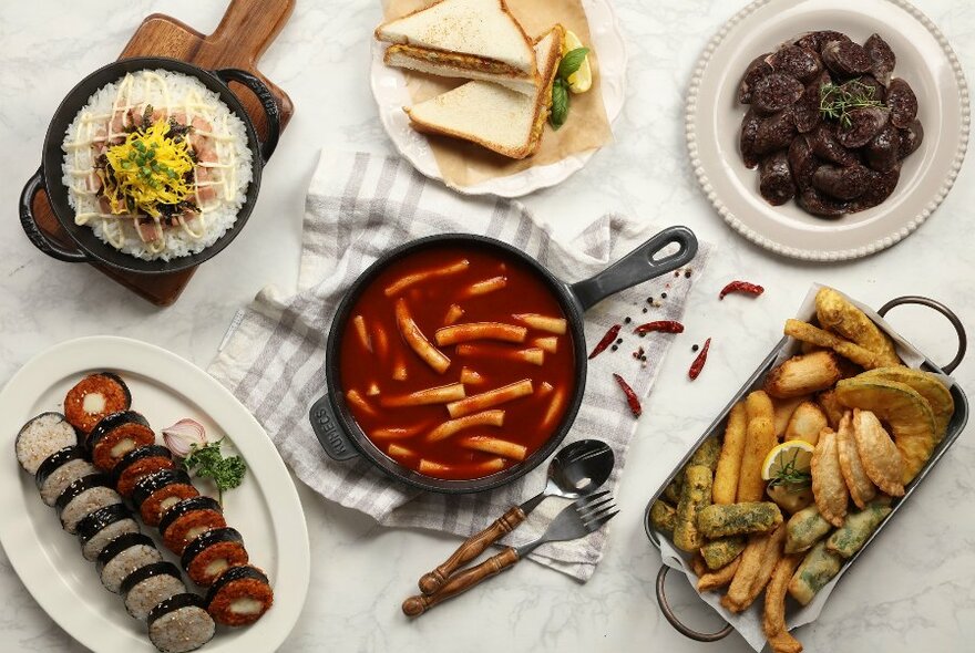 Bird's-eye view of table full of Korean dishes.