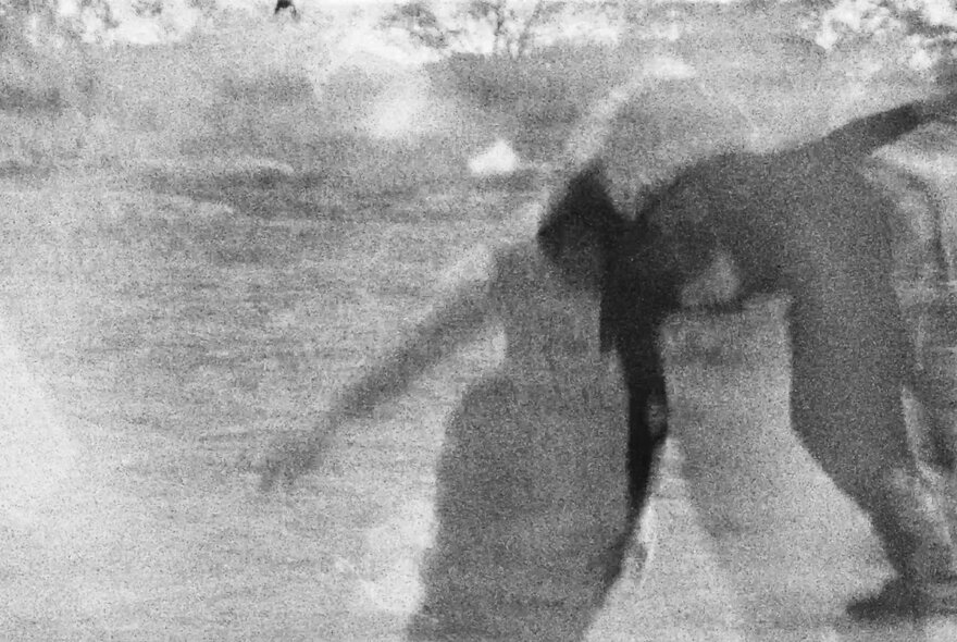 Abstract and grainy overlayed image of people in black and white