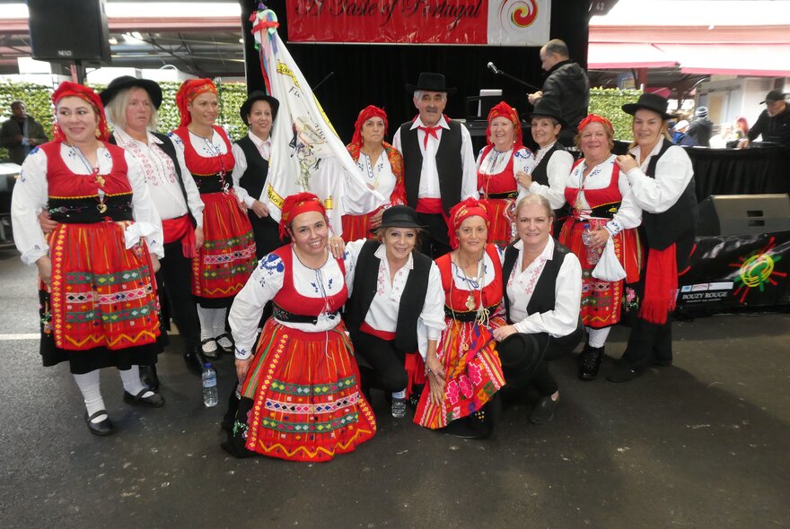 A dance troupe in colourful national costumes, posing as part of the Taste of Portugal festival at Queen Victoria Market.
