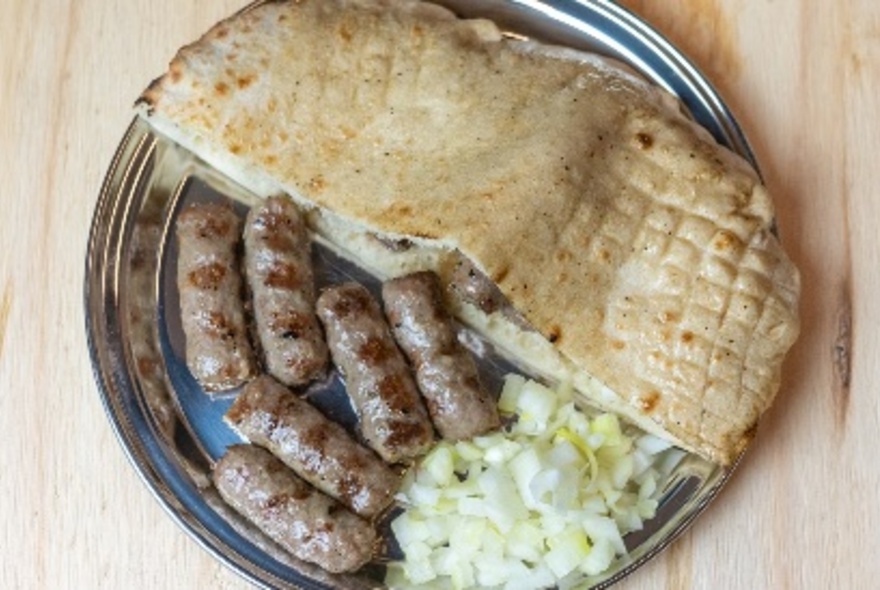 Pita style bread filled with cevapi sausage and onion.