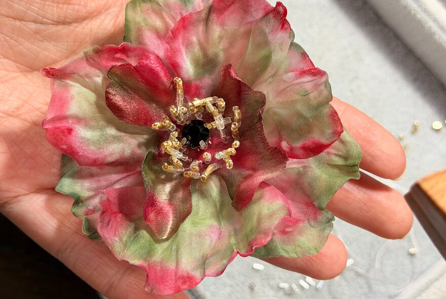 Floral accessorie made from silk and beads.