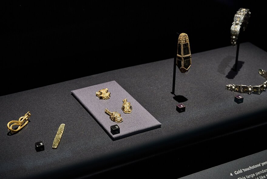 Installation view of objects on jewellery and other small objects on display from Treasures of the Viking Age: The Galloway Hoard at Melbourne Museum.