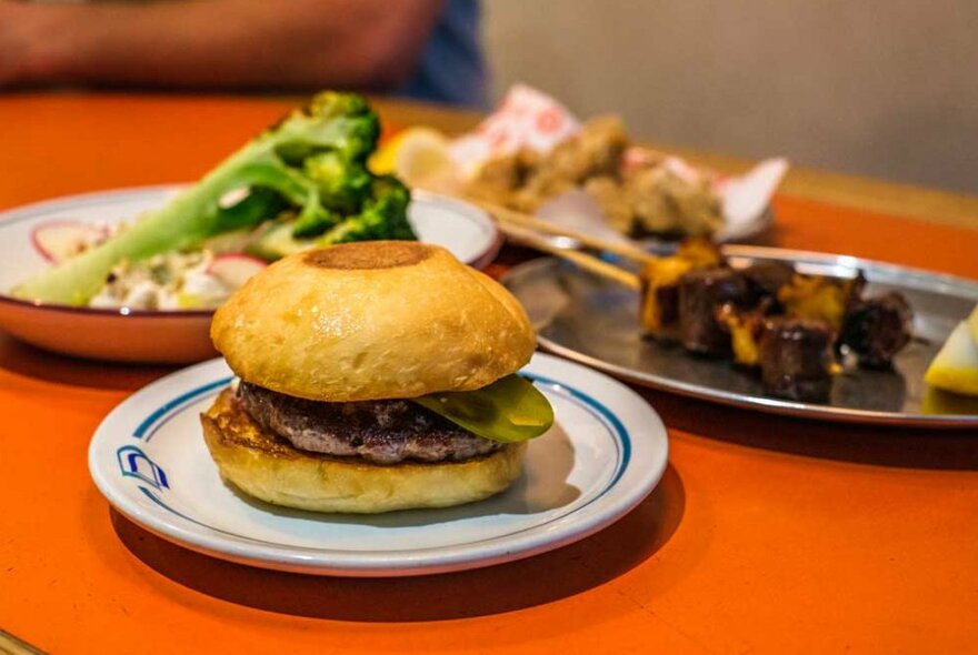 A cheeseburger on a plate at a restaurant