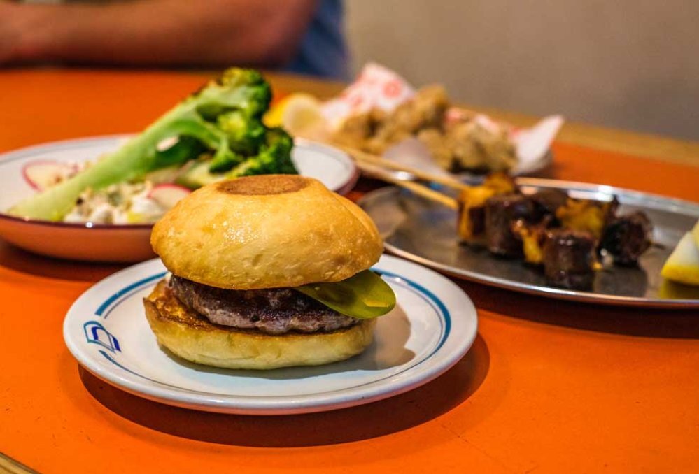 A cheeseburger on a plate at a restaurant