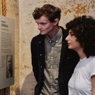 Two young adults looking at a display in the Old Melbourne Gaol.