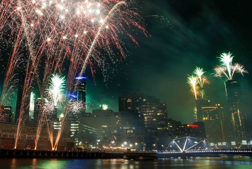 Fireworks on the Yarra River and from city buildings.