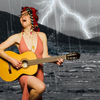 A woman with glasses and a red headpiece plays an acoustic guitar and sings passionately while standing in front of a dramatic thunderstorm backdrop.