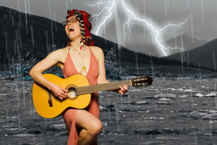 A woman with glasses and a red headpiece plays an acoustic guitar and sings passionately while standing in front of a dramatic thunderstorm backdrop.