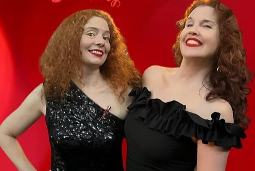 Two redheaded women standing side by side and smiling, both wearing black formal gowns.