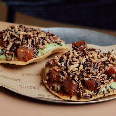 Two loaded tacos on a plate.