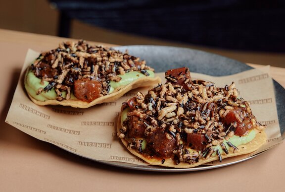 Two loaded tacos on a plate.