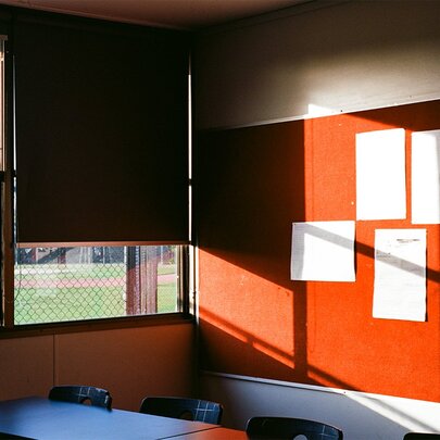 A photograph from artist, Hilary Dodd, showing the bland rear wall of a high school classroom.