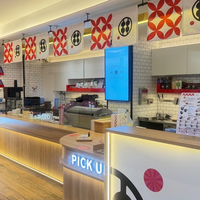 Japanese confectionery store with counters and worktops, signage and banners.