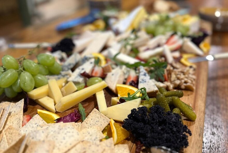 Antipasto selection with cheese, crackers and grapes.