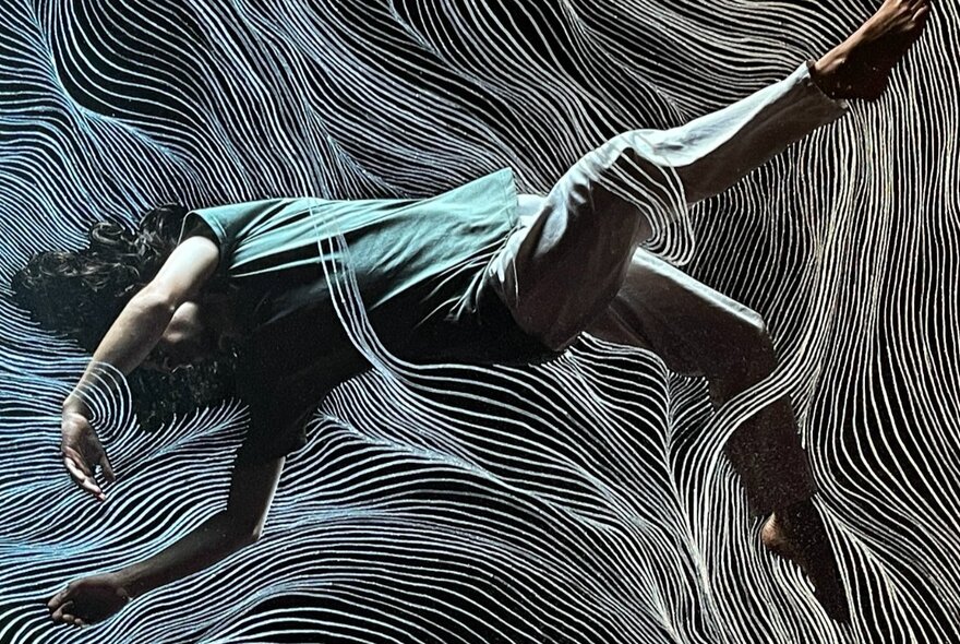Art photograph of a person falling with legs and arms twisted.