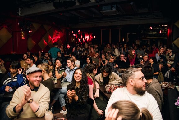A crowd enjoying a live performance inside the Toff in Town venue.