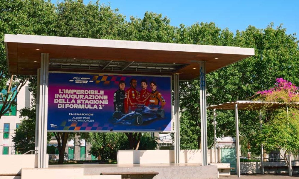 A mural of Formula 1 drivers in an open city square