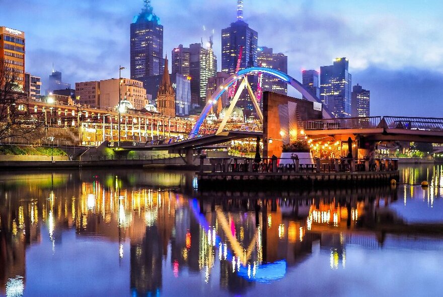 Evan Walker Bridge lit up at night with the city in the background.