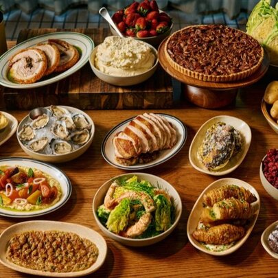 A curated spread of Christmas dishes displayed on a wooden table.