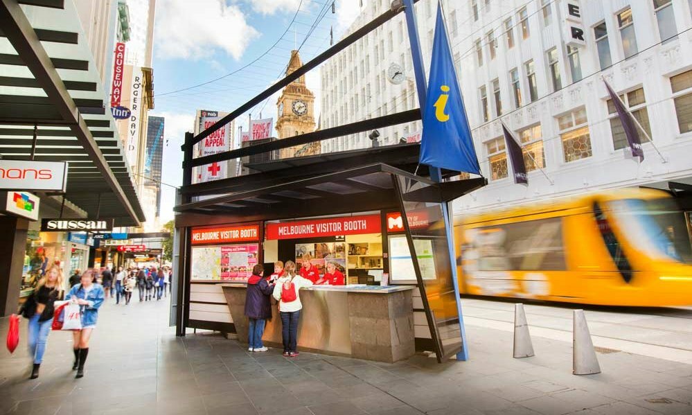 A visitor information booth on a busy city street.