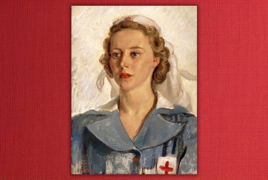 A red framed painted picture of nurse from World War II.