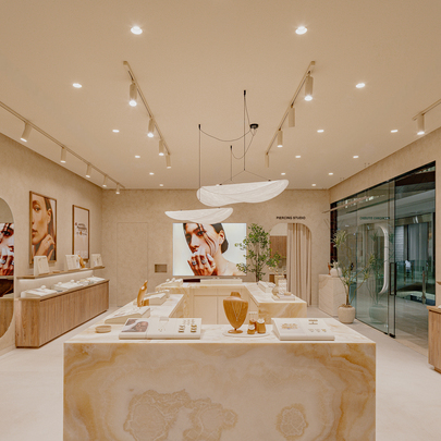 A jewellery boutique with marble displays and pendant lights.