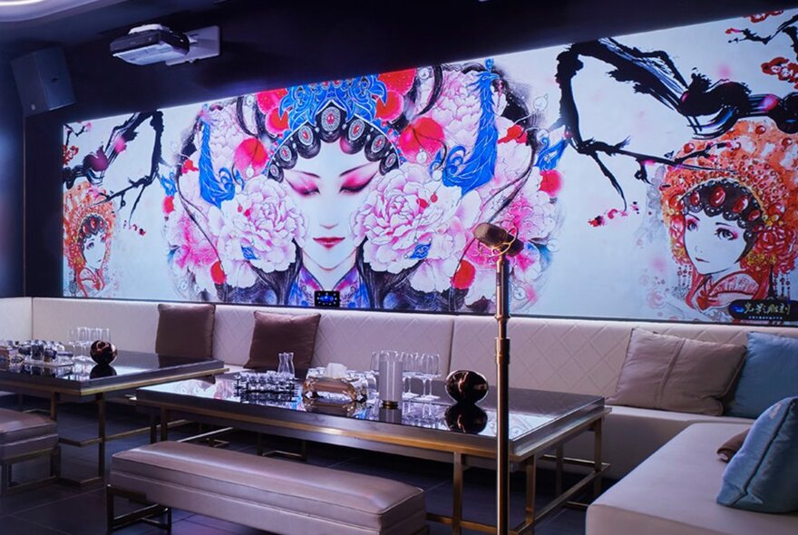 Inside a karaoke room. There is a large mural of a Chinese woman wearing traditional clothing. 