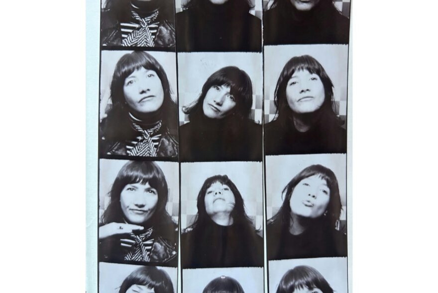 A grid of  black-and-white photo booth strips arranged side by side of a young woman with dark hair and fringe in varied poses. 