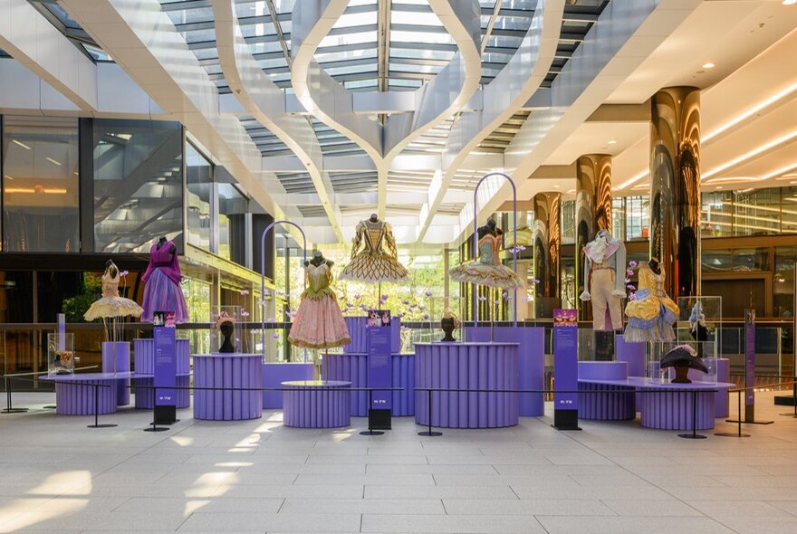 A Melbourne Fashion Week fashion capsule installation of fashion mannequins on plinths, in a public space.