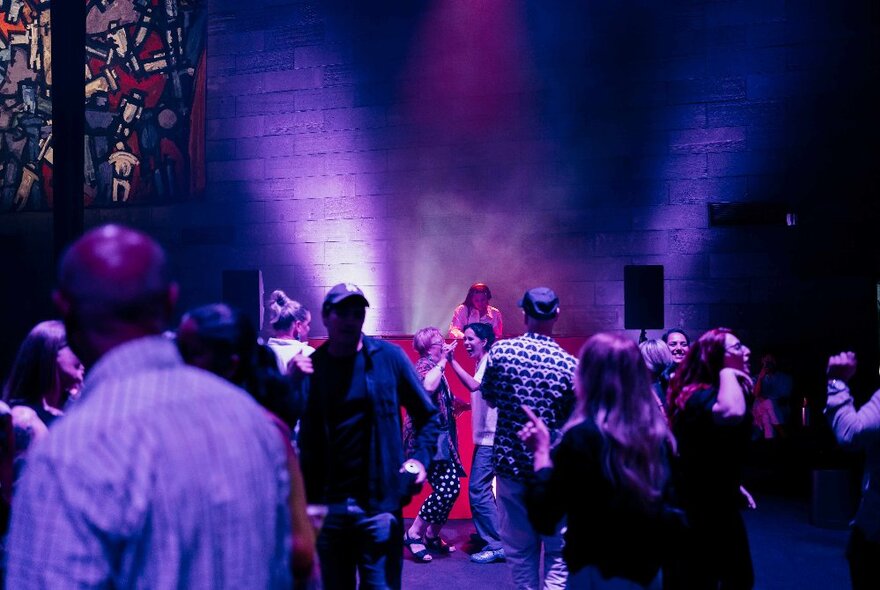 People dancing to a DJ inside the Great Hall at NGV International, at their Friday Night events.
