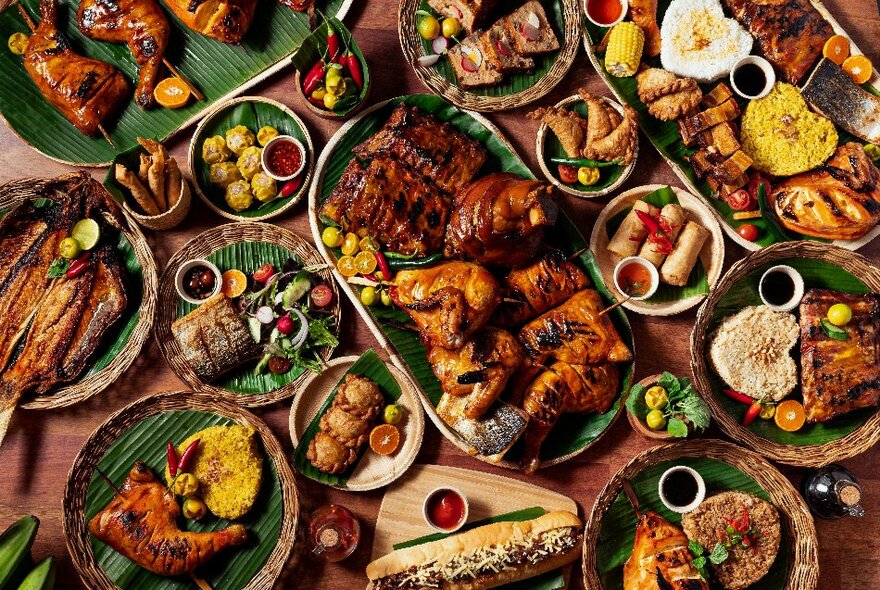 Looking down at a table filled with many platter and plates of food.