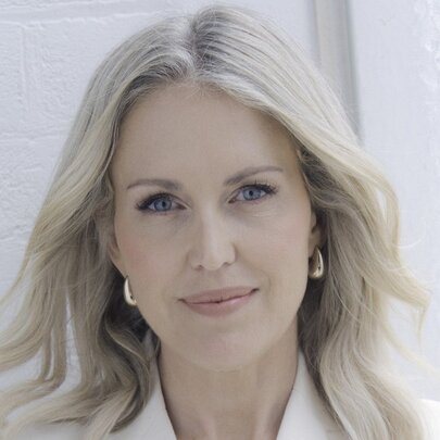 International human rights lawyer Jennifer Robinson, a woman with fair hair and gold hoop earrings, looking directly at the camera with a slight smile.