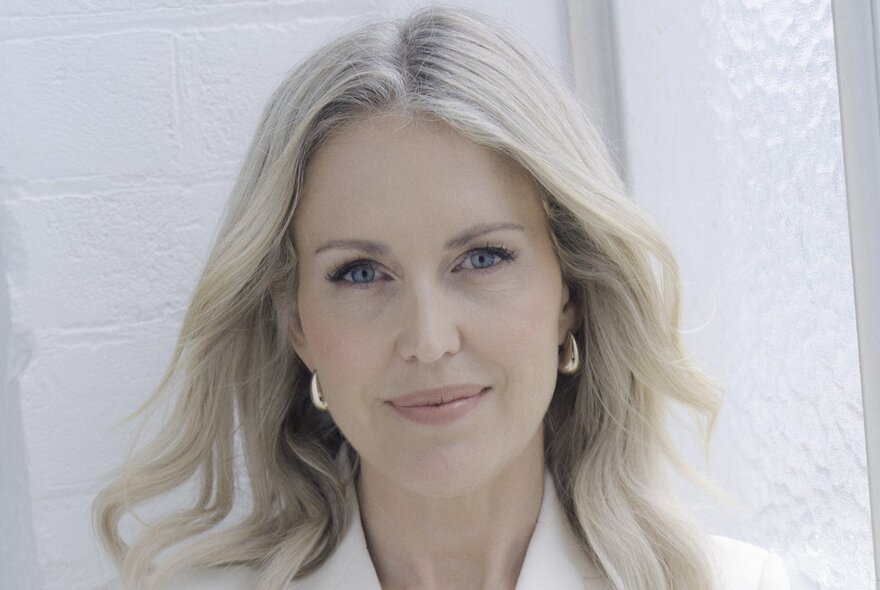 International human rights lawyer Jennifer Robinson, a woman with fair hair and gold hoop earrings, looking directly at the camera with a slight smile.