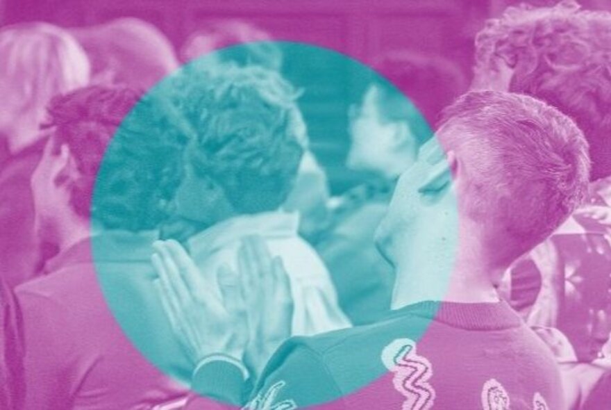 A crowd of seated people from the back, all looking towards the front of a room, one person clapping; the image is tinted with a purple filter and there is a large turquoise circle superimposed over the image.