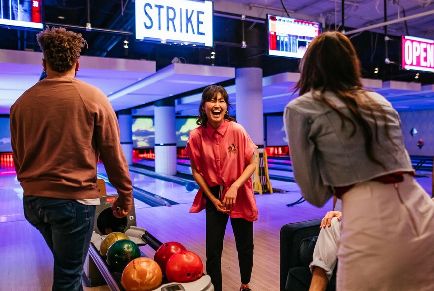 People enjoying tenpin bowling.