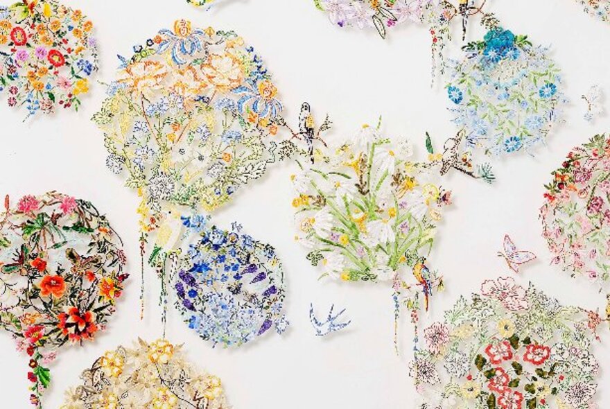 Embroidery artwork with delicate circles of different coloured flowers.