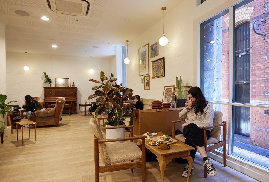 A cafe with old fashioned furniture and plants.