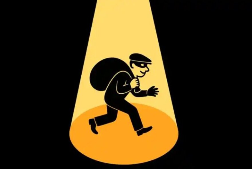 A cartoon burglar wearing a peaked cap and mask, carrying a sack as he creeps through a yellow spotlight.