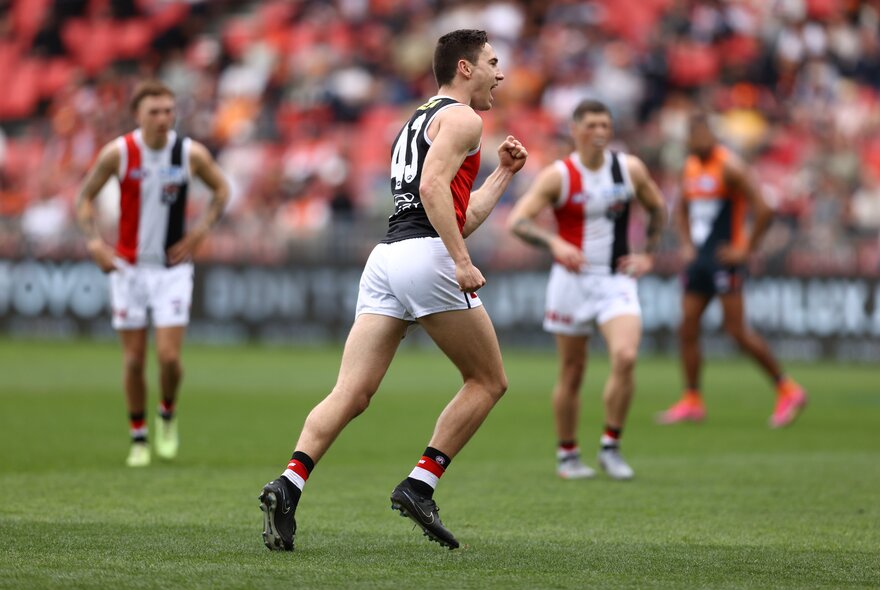 St Kilda AFL football players on the field during a match.
