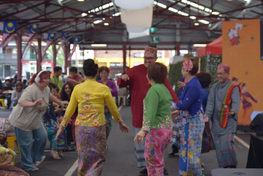 People dancing at the Colours of Malaysia festival at Queen Victoria Market.