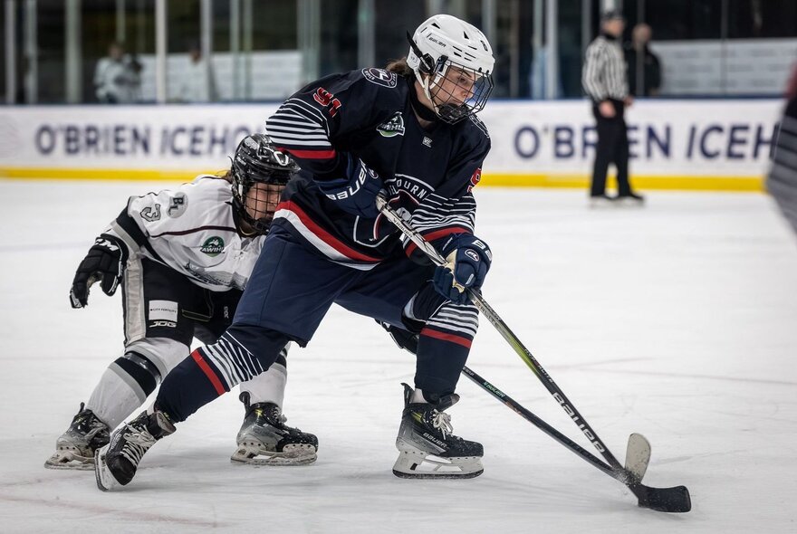 Ice hockey players on the ice during a match.