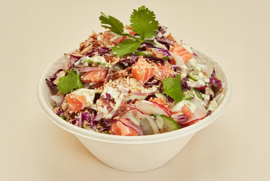 A bowl of fish, noodles and fresh salad vegetables.