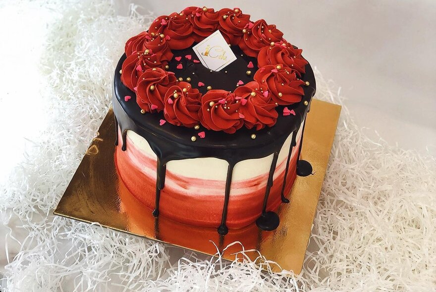 Roses and dripping chocolate decorating a many-tiered cake.