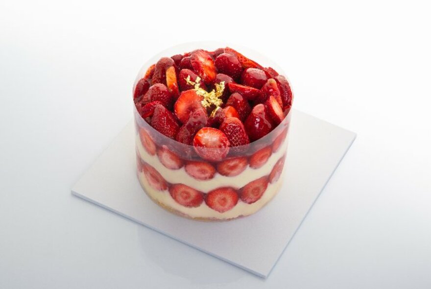 A strawberry shortcake dessert with layers of sponge, cream and fruit.