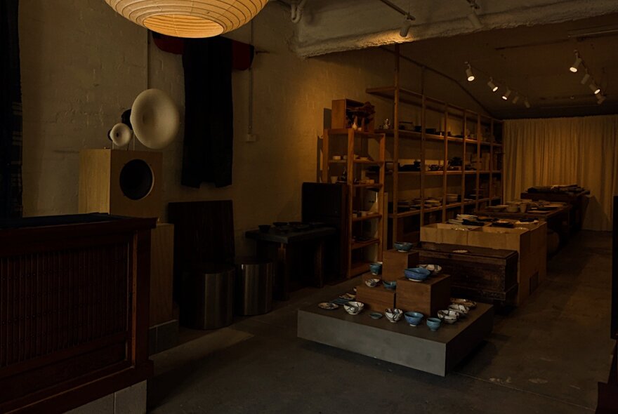 Stylish interior of Nordic Japan Gallery, with ceramics and homewares on display on shelves and on a central display bench.