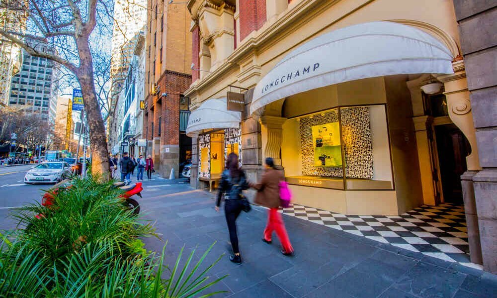 Women walking past a luxury store