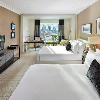 Hotel room with twin beds and city views.