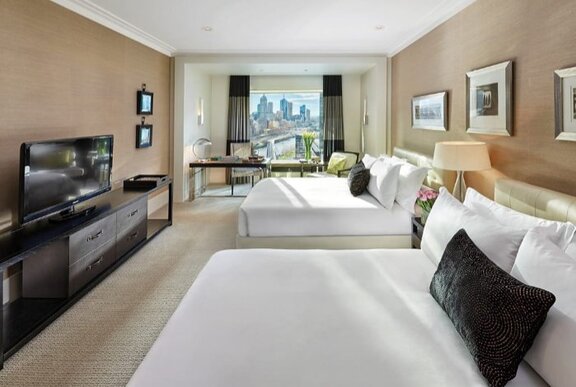 Hotel room with twin beds and city views.