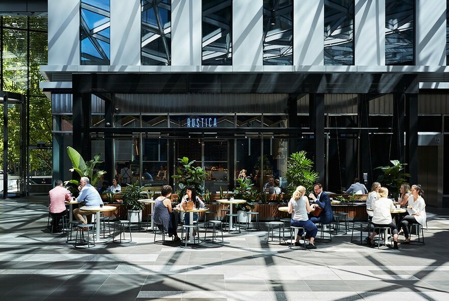 Small groups of customers seated outside Rustica's cafe at Rialto Towers.